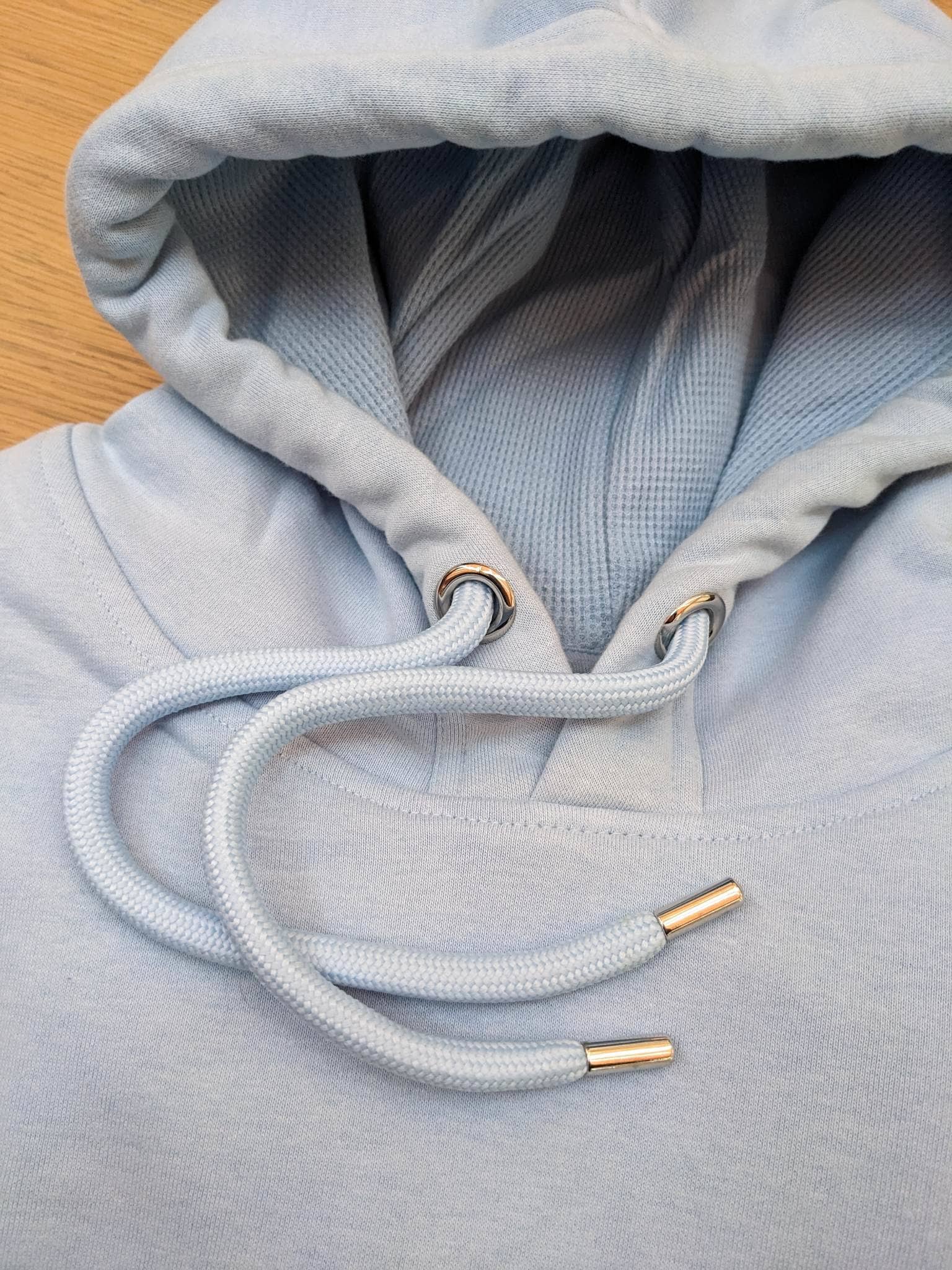 Close up of luxe organic hoody in light blue